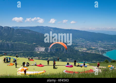 I parapendii preparare e lanciare da Col de la Forclaz sopra il lago di Annecy le Alpi Francia Foto Stock