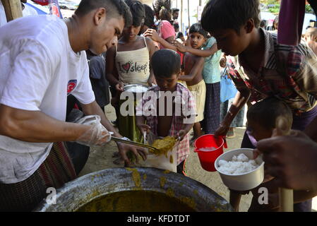 Rohingya i bambini rifugiati raccoglie il cibo al palongkhali campo di fortuna in Cox bazar, Bangladesh, su ottobre 06, 2017. Secondo il regno nat Foto Stock