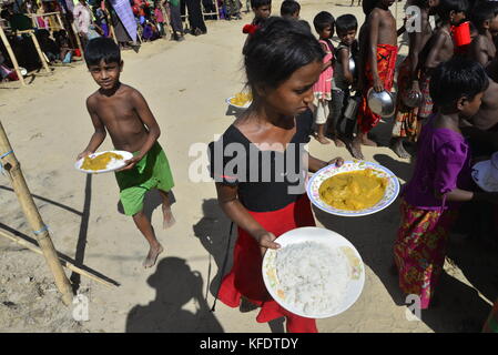 Rohingya i bambini rifugiati raccoglie il cibo al palongkhali campo di fortuna in Cox bazar, Bangladesh, su ottobre 06, 2017. Secondo il regno nat Foto Stock