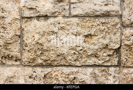 Clos fino di beige muro di pietra texture di superficie di sfondo Foto Stock