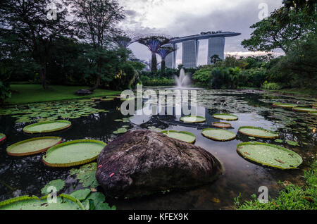 Il marina bay sands come visto dal giardino dall'alloggiamento. La foto è stata scattata al crepuscolo ora con acqua calma per la riflessione della marina bay sands hotel. Foto Stock