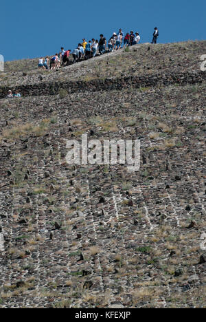 La folla di turisti salire fino alla cima della Piramide del sole e la Piramide della Luna su una soleggiata giornata invernale. Teotihuacan, Città del Messico. Messico Foto Stock