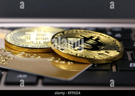 Bitcoins e carta di credito su una tastiera portatile Foto Stock