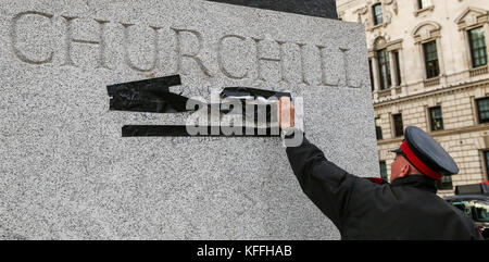 La piazza del parlamento, Londra, Regno Unito. 28 ottobre, 2017. Un operaio bastoni un nastro su graffiti comprendenti la parola "nazista" attraverso Winston Churchill's zoccolo in piazza del Parlamento, di fronte al Palazzo di Westminster comunemente noto come le case del parlamento. La polizia ha arrestato un uomo il 24 ottobre 2017 sul sospetto di danni criminali credito: dinendra haria/alamy live news Foto Stock