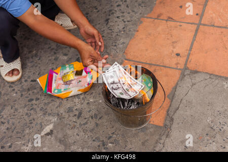 La masterizzazione di denaro (Ghost/denaro votive, Joss carta) in Vietnam Foto Stock