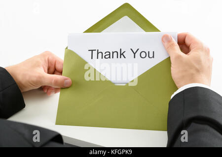 Businessman Holding Thank You Card in Green Envelope Foto Stock