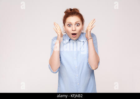 Sì! Isolato studio shot su sfondo grigio di felice successo giovane adulto redhead donna, sentirsi fortunati, guardando la telecamera, emozione e gioia, SMIL Foto Stock