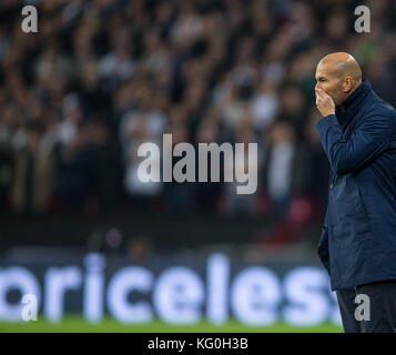 Real Madrid manager Zinedine Zidane tiene il suo volto come inestimabile mostra in background durante la UEFA Champions League match di gruppo tra tottenham Foto Stock