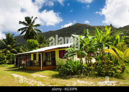 La Seychelles, Praslin, Grand Anse, villaggio tradizionale casa in un lussureggiante giardino tropicale Foto Stock