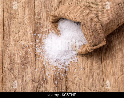 Sale marino nel sacco di iuta sul tavolo di legno Foto Stock