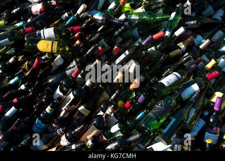 Un sacco di svuotare le bottiglie di vino a impianto di riciclaggio Foto Stock