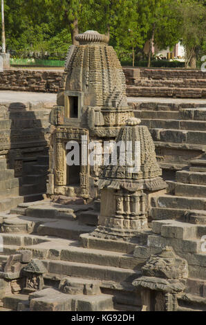 Piccoli santuari e passi per raggiungere il fondo del serbatoio, del tempio del sole ,. modhera villaggio del distretto mehsana, Gujarat, India Foto Stock