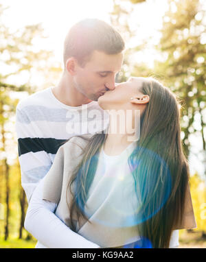 Felice coppia giovane in amore baciare. parcheggiare all'esterno data. amando rapporto di coppia. Foto Stock