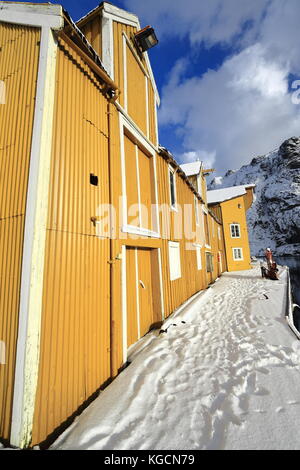 La porta di legno verniciato di magazzino giallo-porte e finestre chiuse e windowframes bianco-coperta di neve gangplank sul pontile in legno-pier il n.lato del Foto Stock