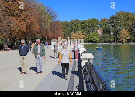 La gente che camminava sulla soleggiata giornata autunnale da Estanque boating pond, El Retiro park, Madrid, Spagna Foto Stock