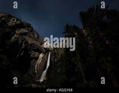 Una rara moonbow rainbow appare sotto Yosemite Falls nel parco nazionale di Yosemite. Foto Stock