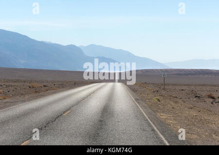 Deserto vuoto road. Death Valley Badwater Road con bacino Badwater scintillante nella distanza. Foto Stock