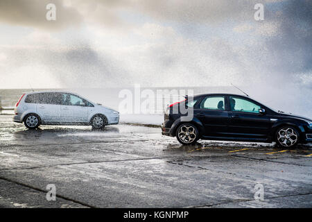 Aberystwyth Galles Regno Unito, venerdì 10 novembre 2017 Regno Unito Meteo: Una giornata di freddo e blu ad Aberystwyth sulla costa occidentale del galles, con venti forti e l'alta marea che si combinano per portare le onde che si infrangono sulle auto parcheggiavano sul lungomare foto Credit: Keith Morris/Alamy Live News Foto Stock