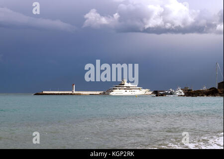 Luxury yachts ancorati nel porto di Antibes in costa azzurra, sotto un cielo tempestoso. Foto Stock