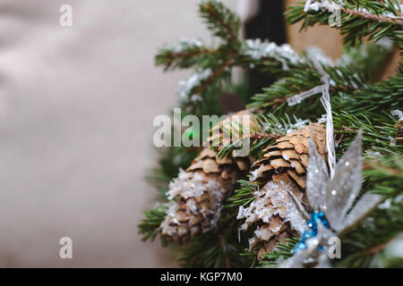 L'abete di Natale rami con coni e decorazioni festive. celebrazione del Capodanno e Natale a casa. vacanze decorazioni e sfondi dai Foto Stock