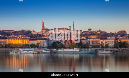 Budapest, Ungheria - Vista Alba del lato Buda di Budapest con il Castello di Buda, la chiesa di San Mattia e il Bastione dei pescatori con vecchie navi sulla Rive Foto Stock