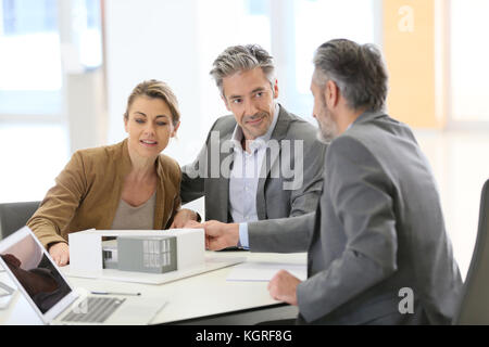 Coppia matura incontro architetto per il progetto di costruzione Foto Stock