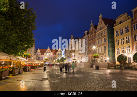 Vista di persone, ristoranti, cancello verde e altri vecchi edifici al mercato lungo, fine del Long Lane, nelle principali città (città vecchia) in Gdansk all'imbrunire. Foto Stock