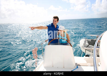 Coppia giovane la navigazione su uno yacht nel mar dei Caraibi Foto Stock