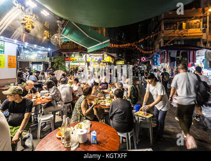 HONG KONG, CINA - 16 GIUGNO 2017: I turisti e i locali cenano in un ristorante nelle strade di Kowloon vicino al famoso mercato notturno del Tempio di Hong Kong. Foto Stock