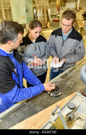 Gli studenti a prendere appunti nel corso del workshop Foto Stock