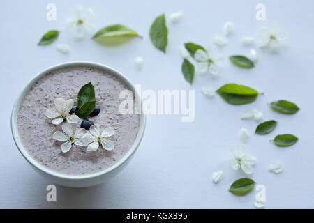 Farina di avena porridge realizzato di avena, purea di banana, latte di mandorla e frutti di bosco, tutti mescolati insieme, isolato su sfondo bianco Foto Stock