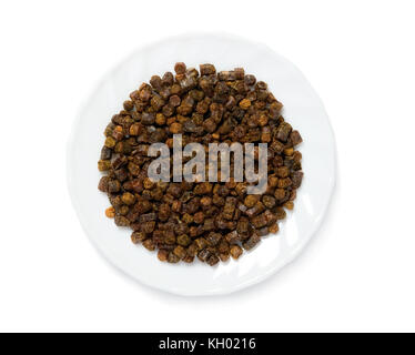 Granuli di propoli all'interno della piastra sullo sfondo, prodotto delle api Foto Stock