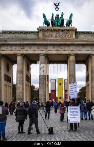 Berlino, Mitte. 12 Novembre, 2017. Illustrazione di installazione 'Monument' da artista German-Syrian Manaf Halbouni davanti alla Porta di Brandeburgo. Tre autobus sconvolto formano una barricata difensiva come le barriere erette di Aleppo Siria per proteggere le persone dai cecchini. La copertina è parte del terzo evento Herbstsalon dalla Maxim Gorki theater. Credito: Eden Breitz/Alamy Live News Foto Stock