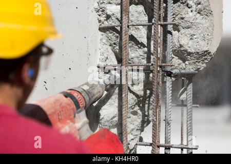 Operaio edile utilizzando una testa di foratura power tool Foto Stock