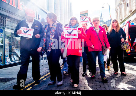 Achub / Salva Bodlondeb marcia di protesta e un gruppo di persone di tutte le età in marcia attraverso le strade di Aberystwyth Wales UK, portante Welsh bilingue Inglese/banner, per protestare contro il Ceredigion County Council piani per chiudere Bodlondeb, il locale la casa di cura per gli anziani, nel suo ultimo round di finanziamento di bilancio tagli. 16 settembre 2017 Foto Stock