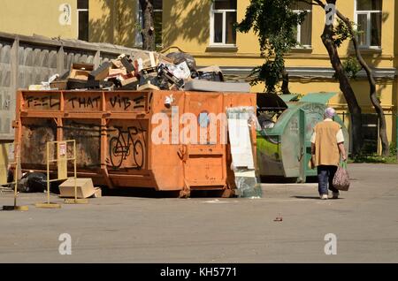 02.07.2016.La russia,saint-petersburg.una donna senzatetto cerca tra i detriti di residui di cibo. Foto Stock