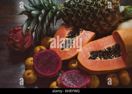 Succosa frutta esotica. Ananas, papaya, mango, dragon frutta sul tavolo pronti a mangiare Foto Stock