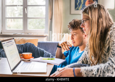 Due studenti seduti davanti a un computer portatile, apprendimento sul computer, Monaco di Baviera, Germania Foto Stock