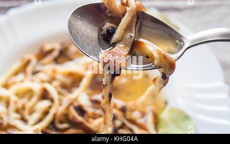 Pancake di zuppa, vicino sul cucchiaio, tradizionale austriaca che serve, tovaglie Foto Stock