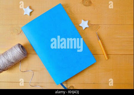 Natebook blu mockup con matite colorate su un tavolo di legno. Modello foto Flat lay, vista dall'alto Foto Stock