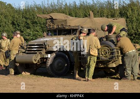 Guerra mondiale due re-enactors in US Army uniformi, con M3 a mezza via e Jeep Willys, Cosby vittoria mostra, UK. Foto Stock