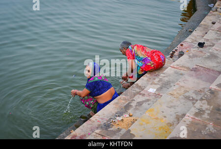 Pushkar, India - 5 nov 2017. Le donne indiane la balneazione e pregando vicino al lago santo in pushkar, India. pushkar è una città nel distretto di Ajmer in st Foto Stock