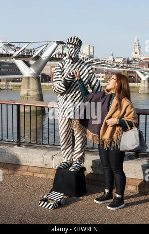 Statua umana in bianco e nero strisce da Millennium Bridge, London, Regno Unito Foto Stock