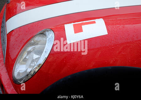 Il bianco e il rosso mini auto con un allievo sulla piastra del parafango anteriore England Regno Unito Foto Stock