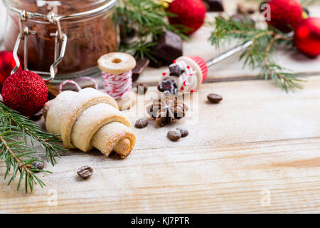 Caramelle di Abete rami e baubles rossa sopra la luce sullo sfondo di legno Foto Stock