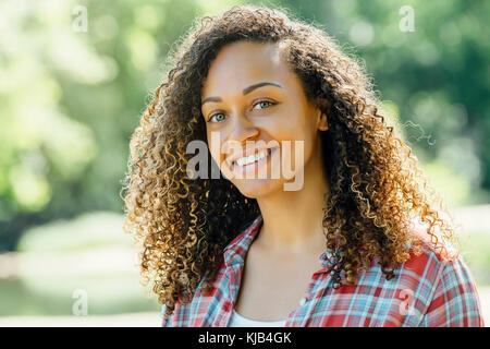 Ritratto di sorridere razza mista donna all'aperto Foto Stock