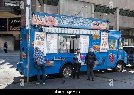 Toronto, Canada - 16 ottobre 2017: Persone che pranzano presso un hot dog e un food truck nella città di Toronto Foto Stock