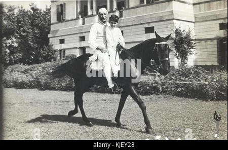 Questa fotografia storica mostra Jawaharlal Nehru, il primo primo ministro indiano, insieme a suo figlio Sanjay Gandhi, entrambi a cavallo. Cattura un momento nella loro vita durante la metà del XX secolo. Foto Stock