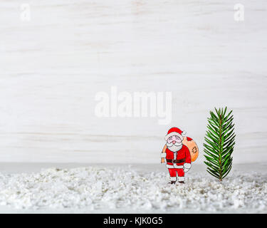 Anno nuovo sfondo. la figura di santa claus è fatto di carta. billetta per cartoline o congratulazioni. Nella foresta tra i cumuli di neve. copia s Foto Stock