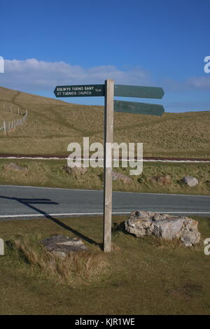 Visualizzazione verticale di un segno posto in Llandudno sul Great Orme con linee ferroviarie in background Foto Stock